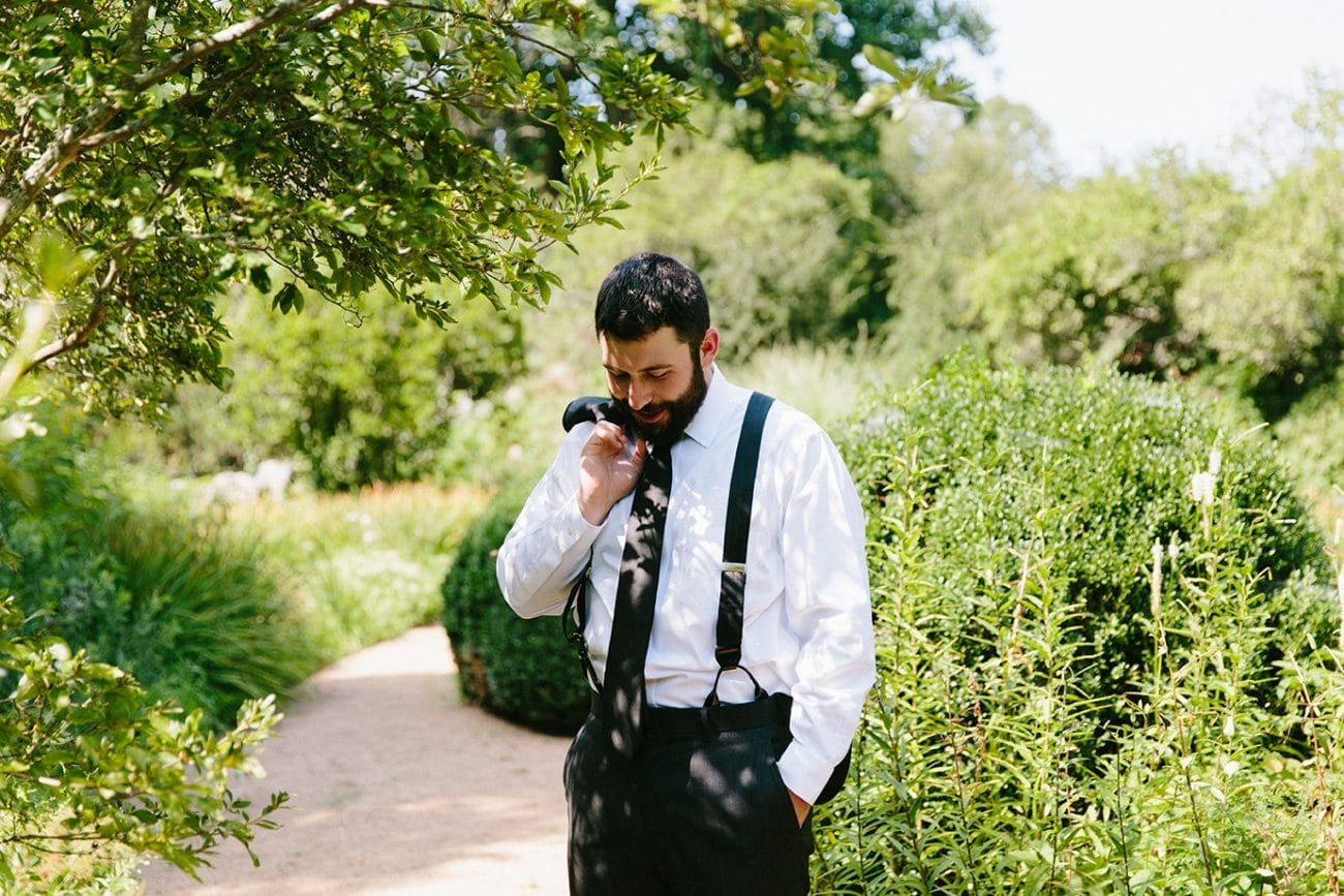 A documentary photograph of a groom waiting to see his bride during a Moraine Farm wedding in Beverly, Massachusetts