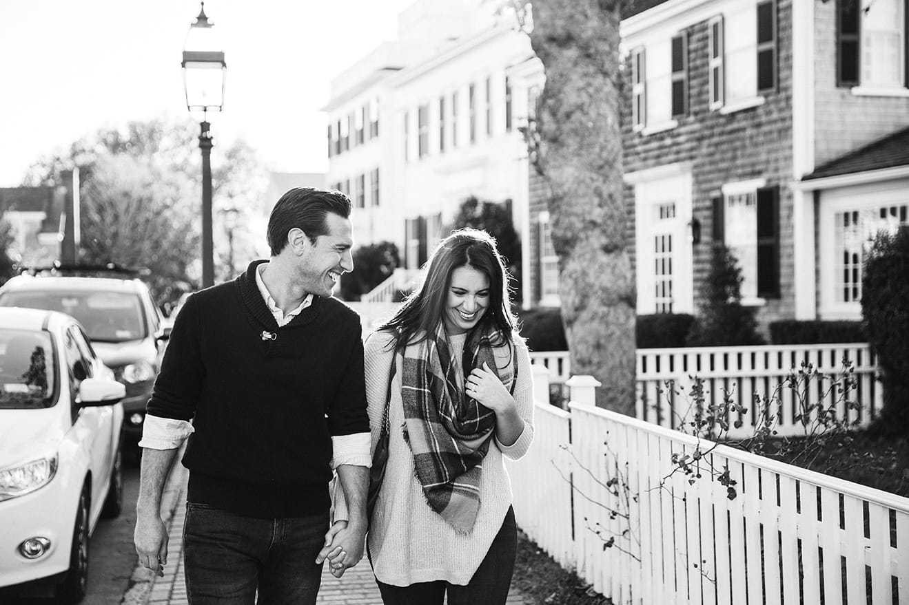 A documentary photograph of a couple walking, talking and laughing during their honeymoon photo session on Martha's Vineyard