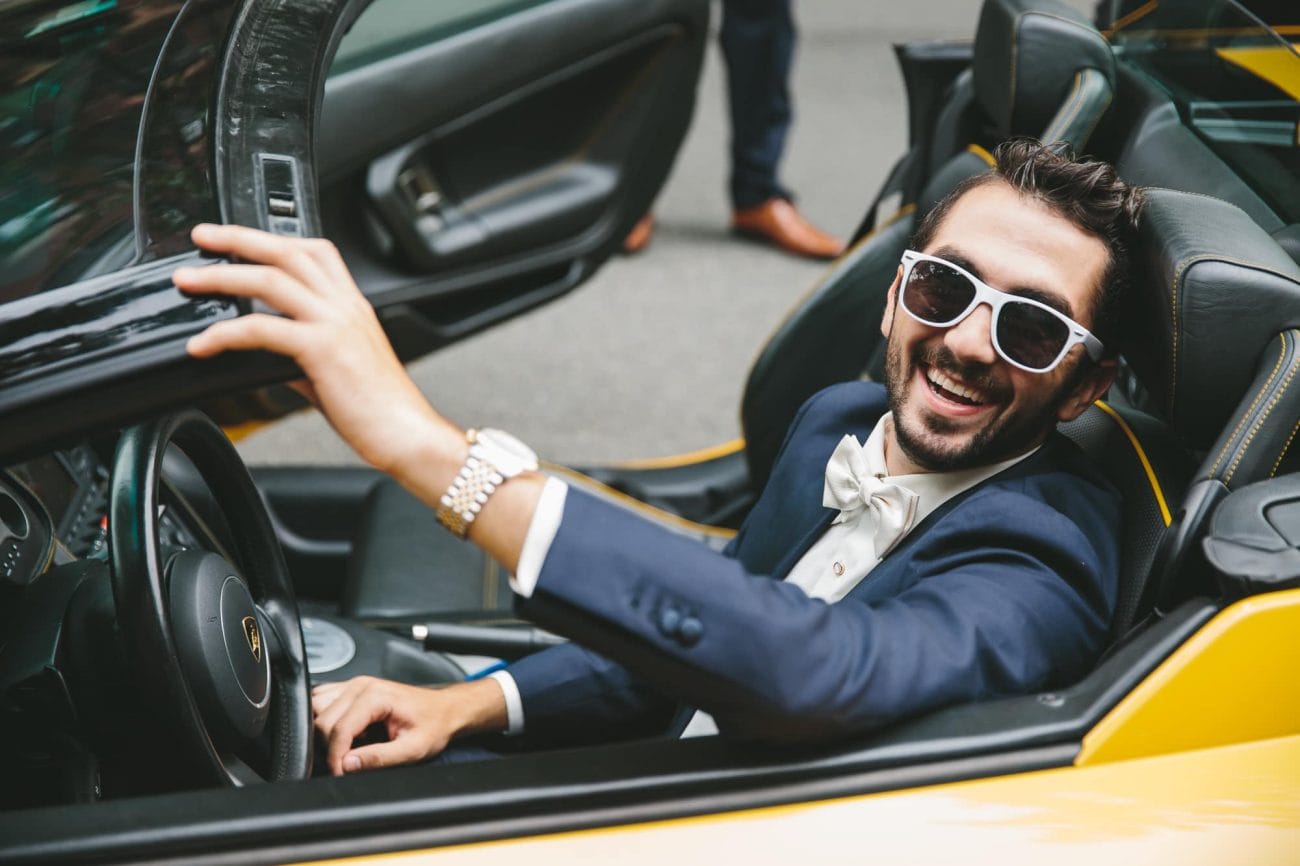 A photograph of a groom before he drives a rented lamberghini to his State Room Wedding