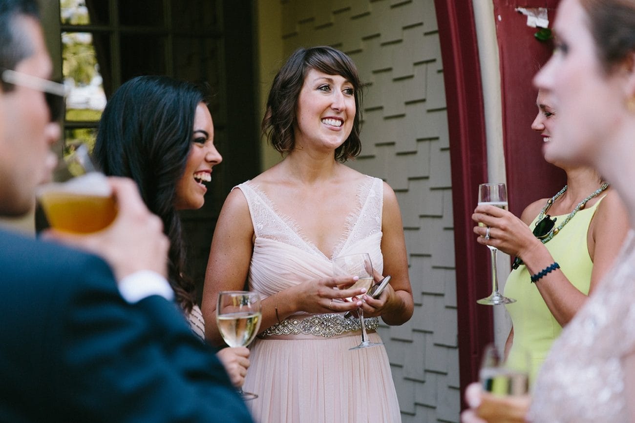 A documentary photograph of guest laughing during a Moraine Farm Wedding in Beverly, Massachusetts