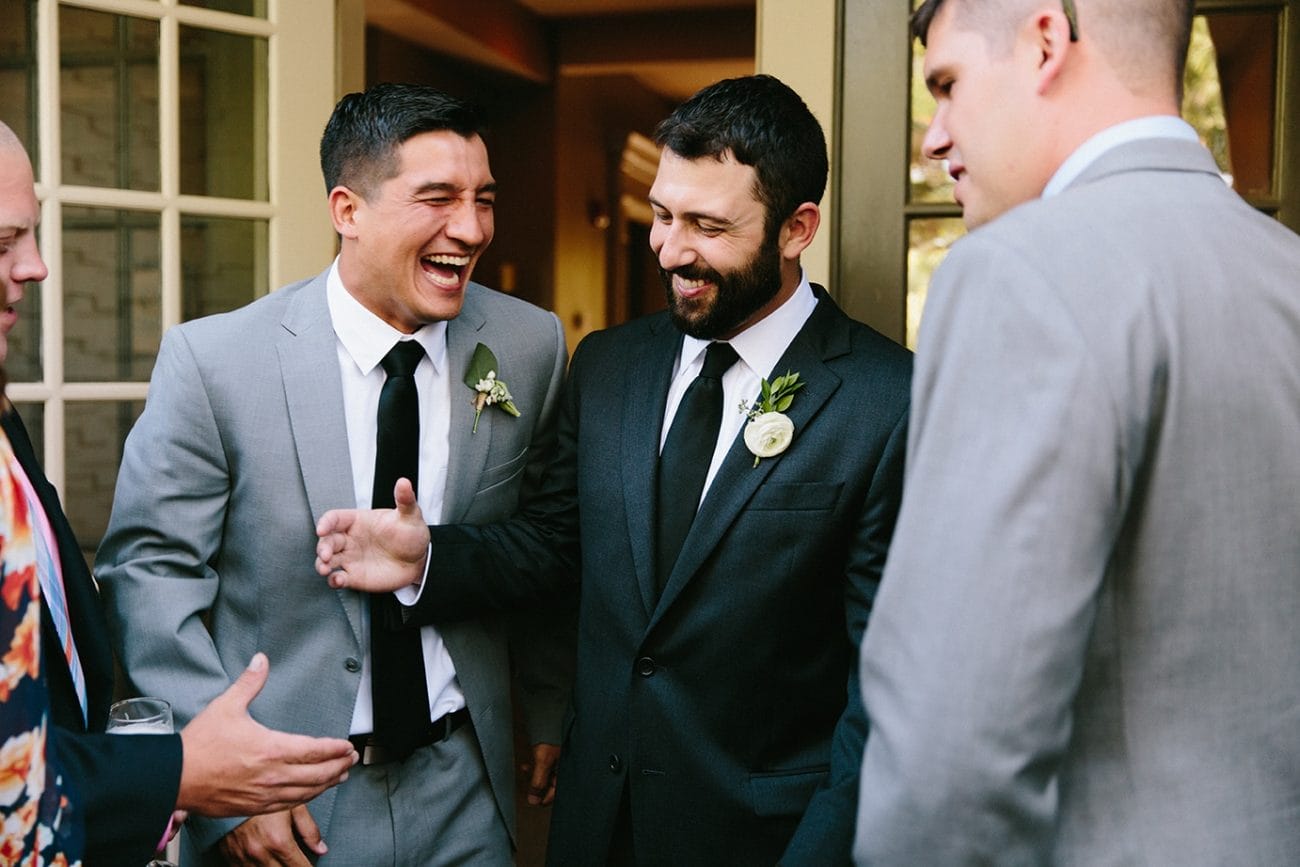 A documentary photograph of guests laughing during a Moraine Farm Wedding in Beverly, Massachusetts