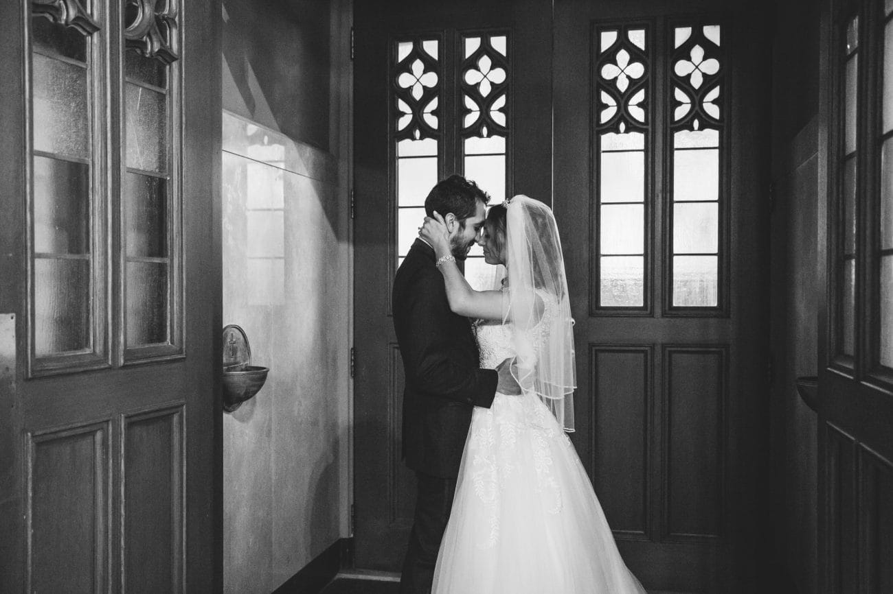 A documentary photograph of a couple spending a few moments alone as newly weds before their State Room Wedding Reception in Boston, Massachusetts