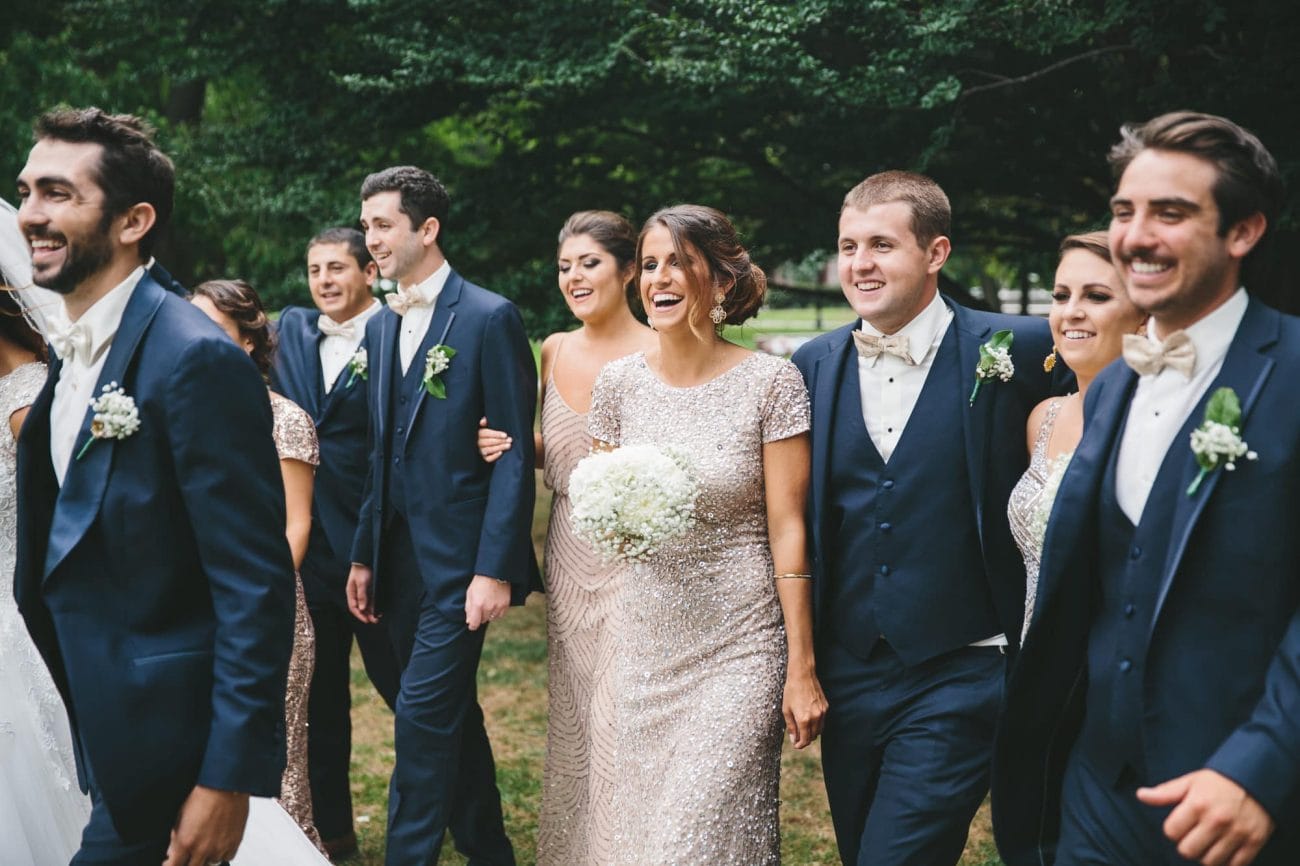 A documentary photograph of a wedding party hanging out at the Boston Public Gardens during a State Room Wedding in Boston, Massachusetts