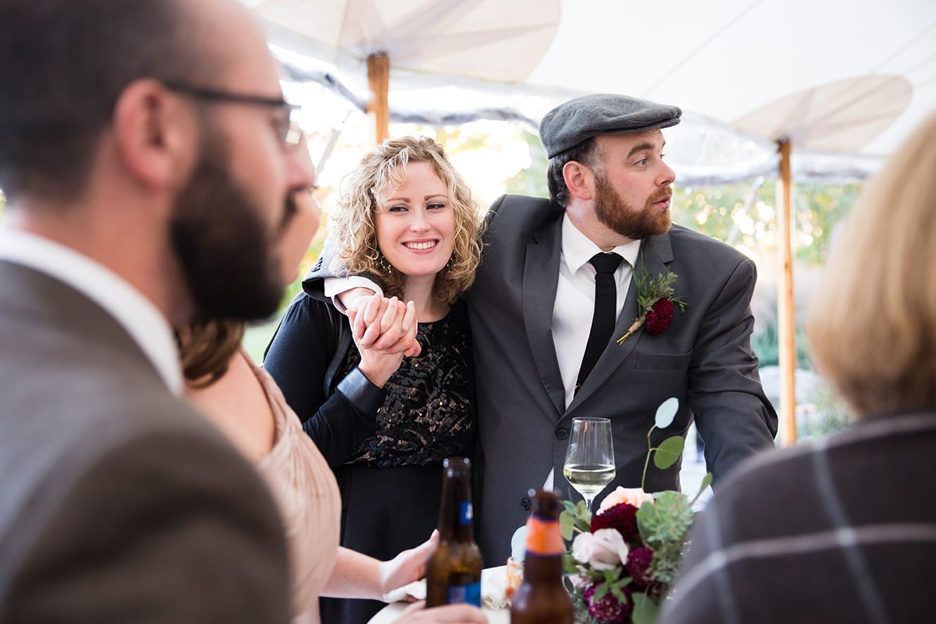 A documentary photograph of a couple at the cocktail hour of a Harrington Farm Wedding in Princeton, Massachusetts