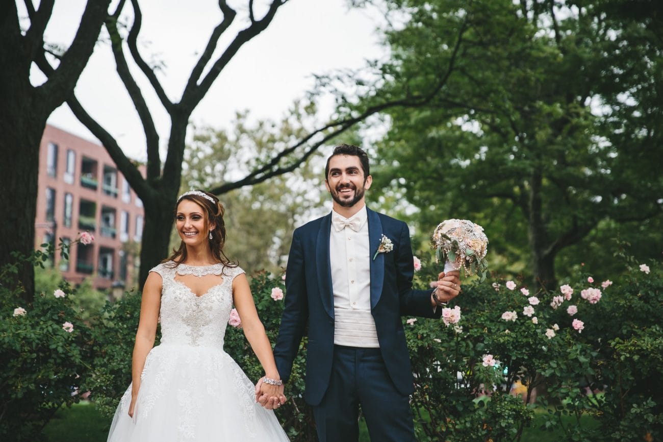 A natural portrait of a bride and groom in Christopher Columbus park during their State Room Wedding