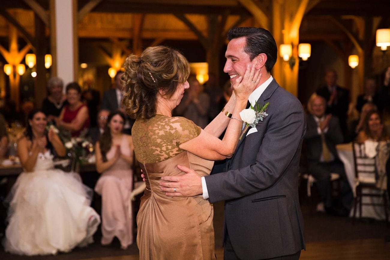 A documentary photograph of a groom dancing with his mom during his Harrington Farm Wedding in Princeton, Massachusetts