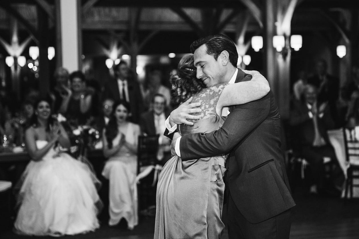 A documentary photograph of a groom hugging his mom during his Harrington Farm Wedding in Princeton, Massachusetts