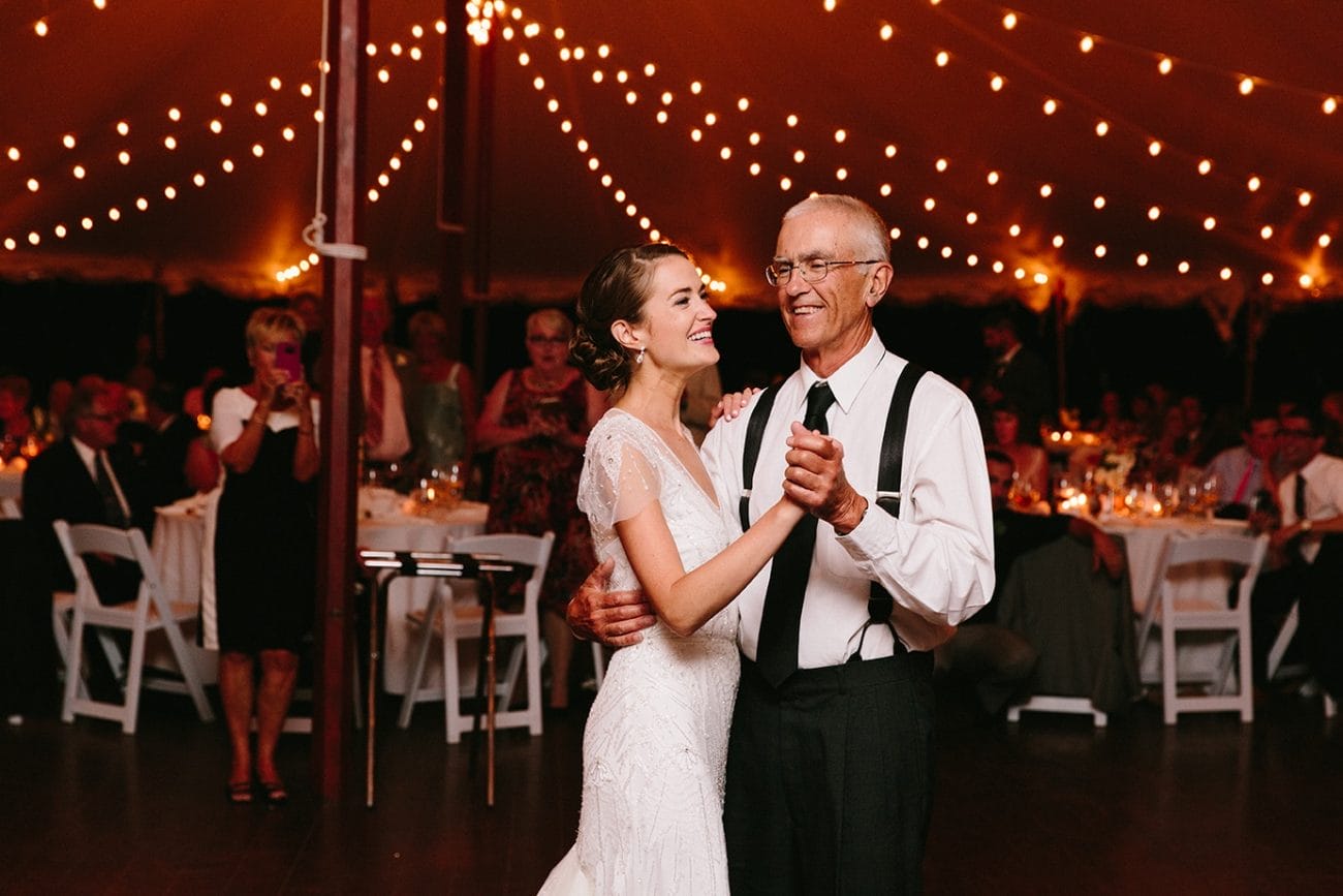 A documentary photograph of a bride dancing with her father during her Moraine Farm Wedding in Beverly, Massachusetts