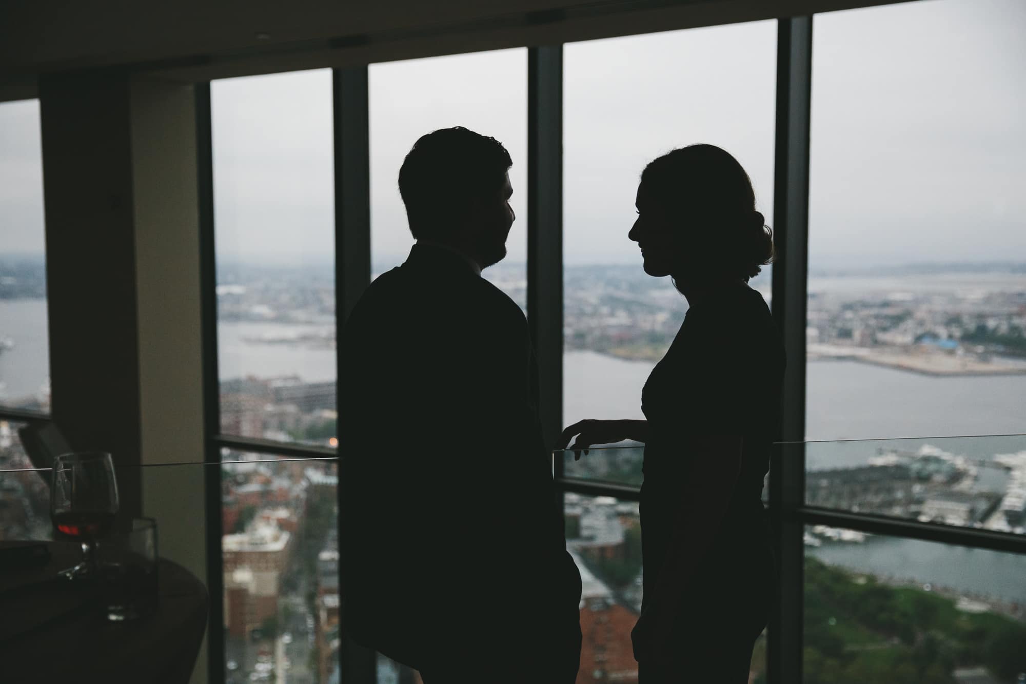 A documentary photograph of guests talking at the cocktail hour of a State Room Wedding in Massachusetts