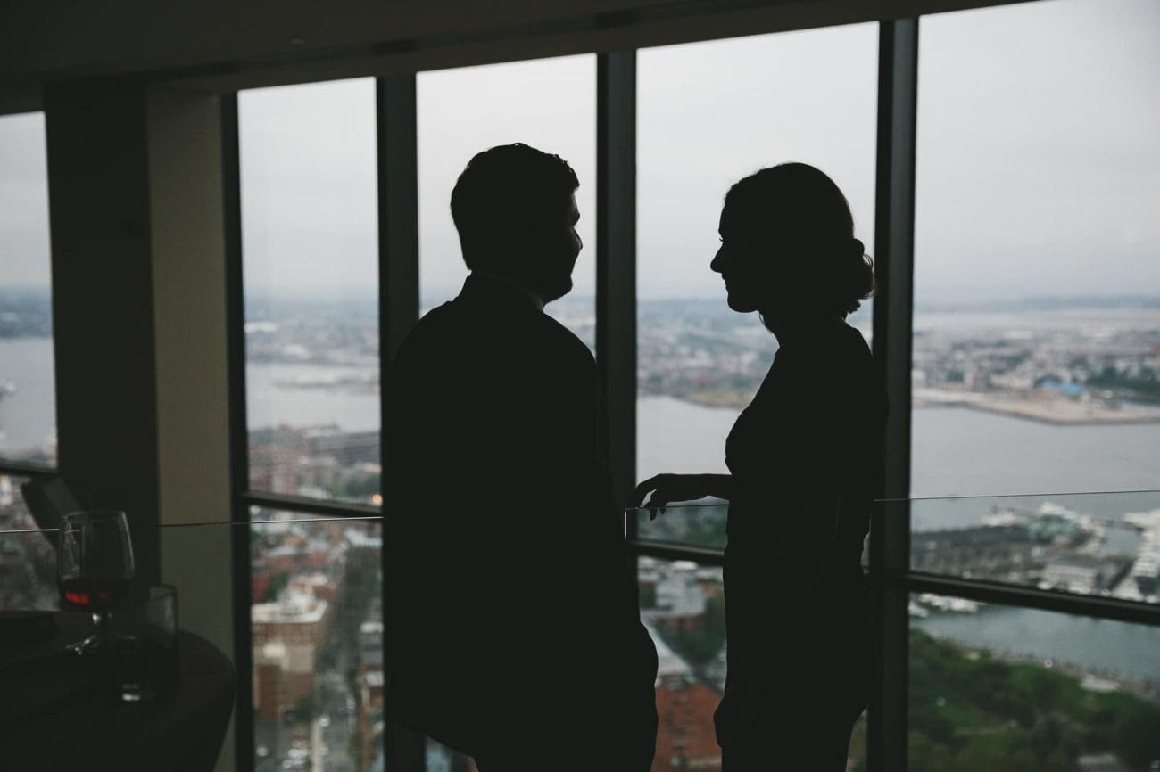 A documentary photograph of guests talking at the cocktail hour of a State Room Wedding in Massachusetts