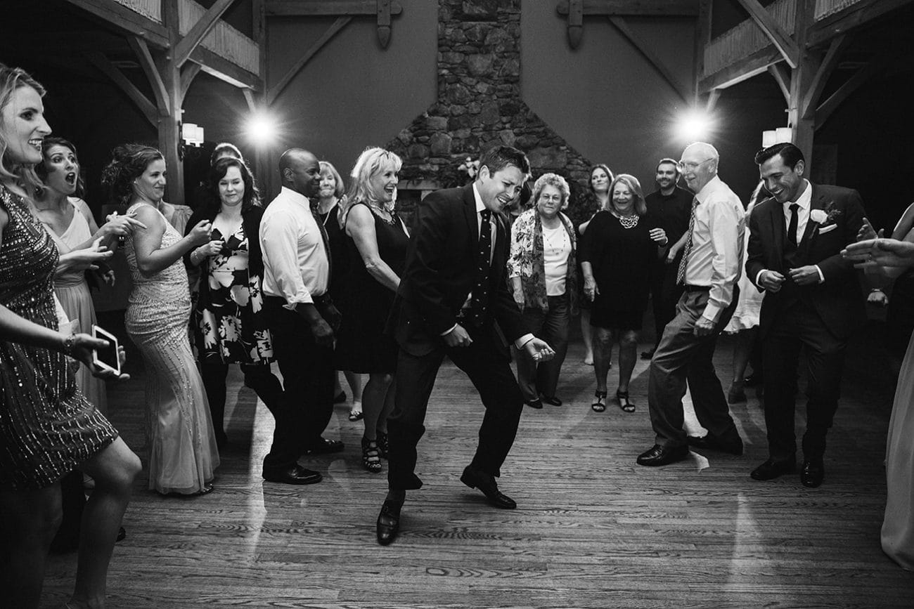 A documentary photograph of guests dancing at a Harrington Farm Wedding in Princeton, Massachusetts