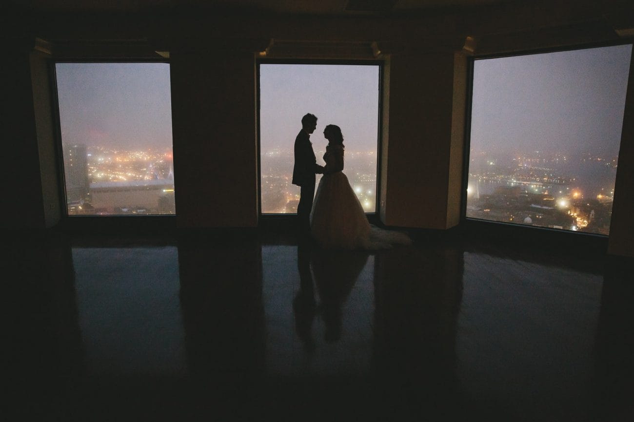 An artistic photograph of a bride and groom at night during their State Room Wedding in Boston, Massachusetts