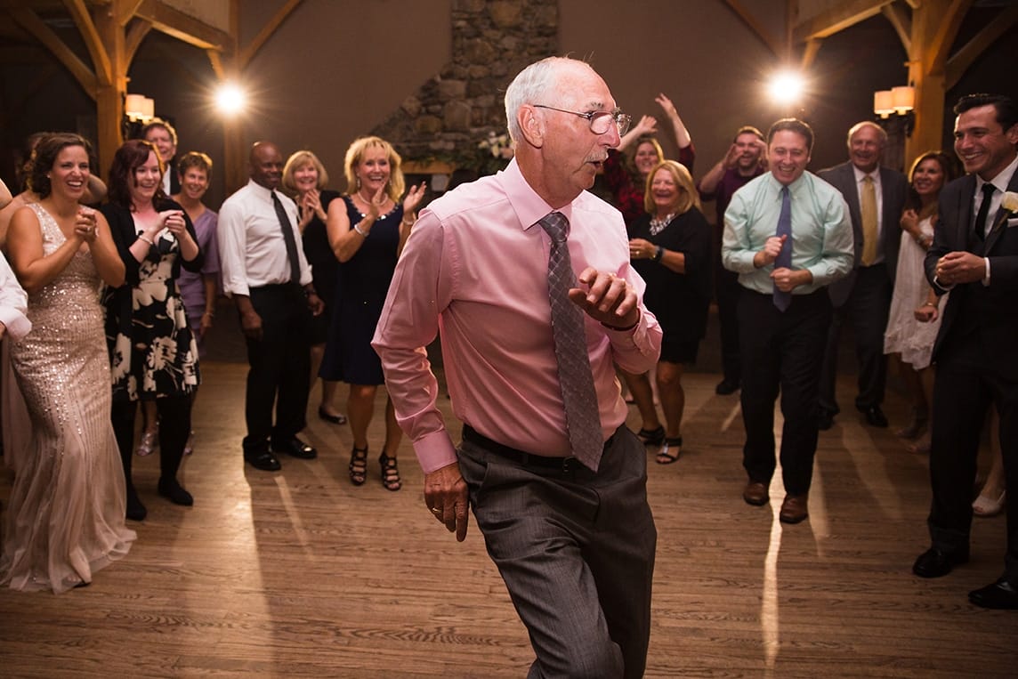 A documentary photograph of guests dancing during a Harrington Farm Wedding in Princeton, Massachusetts