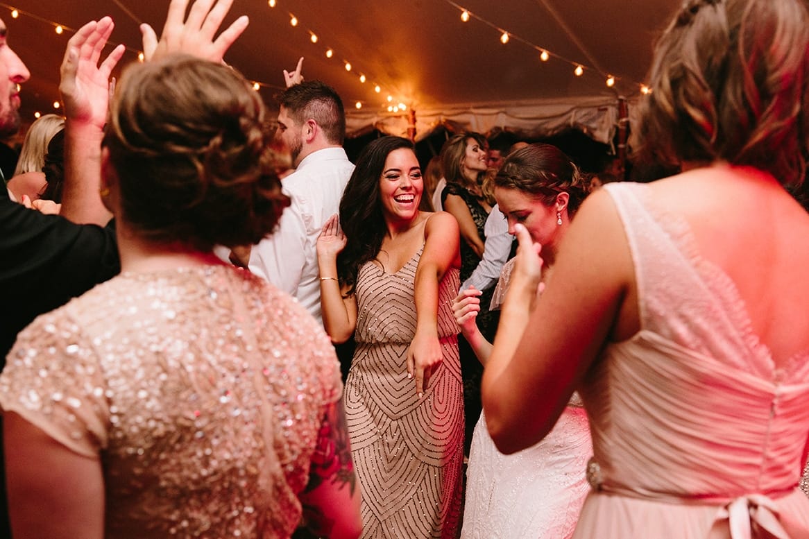 A documentary photograph of guests dancing during a Moraine Farm Wedding in Beverly, Massachusetts