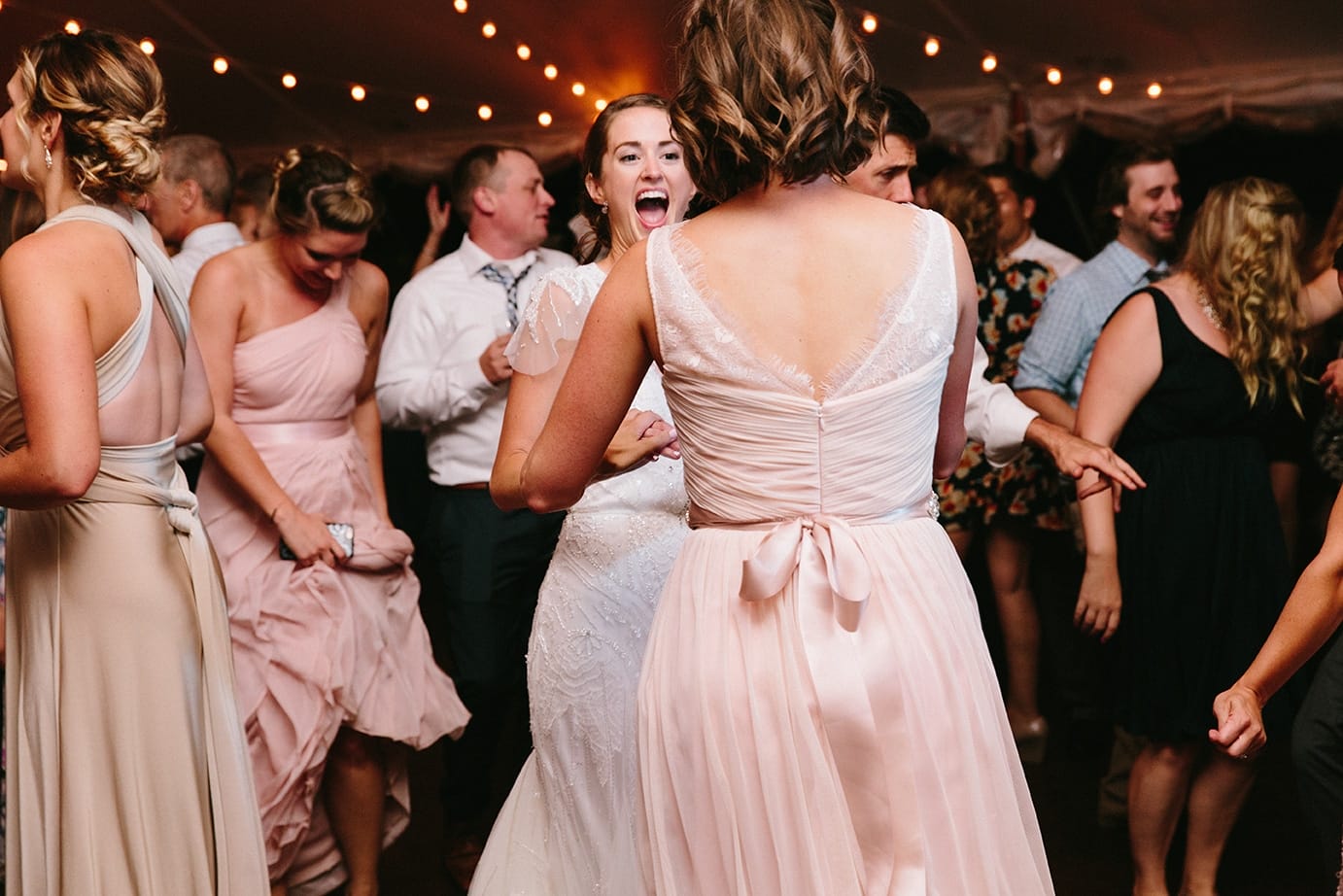 A documentary photograph of guests dancing during a Moraine Farm Wedding in Beverly, Massachusetts