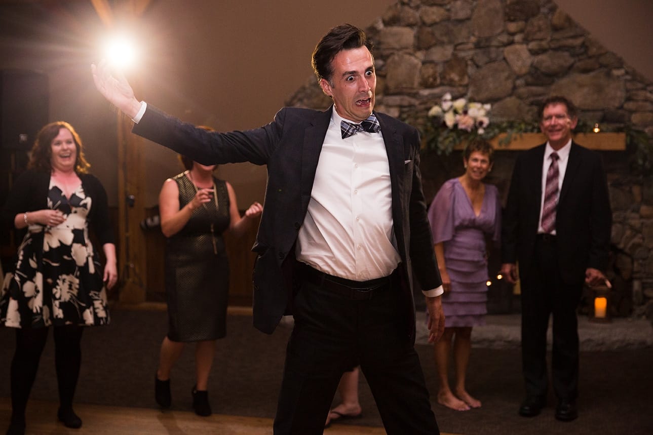 A documentary photograph of a guest dancing at a Harrington Farm Wedding in Princeton, Massachusetts