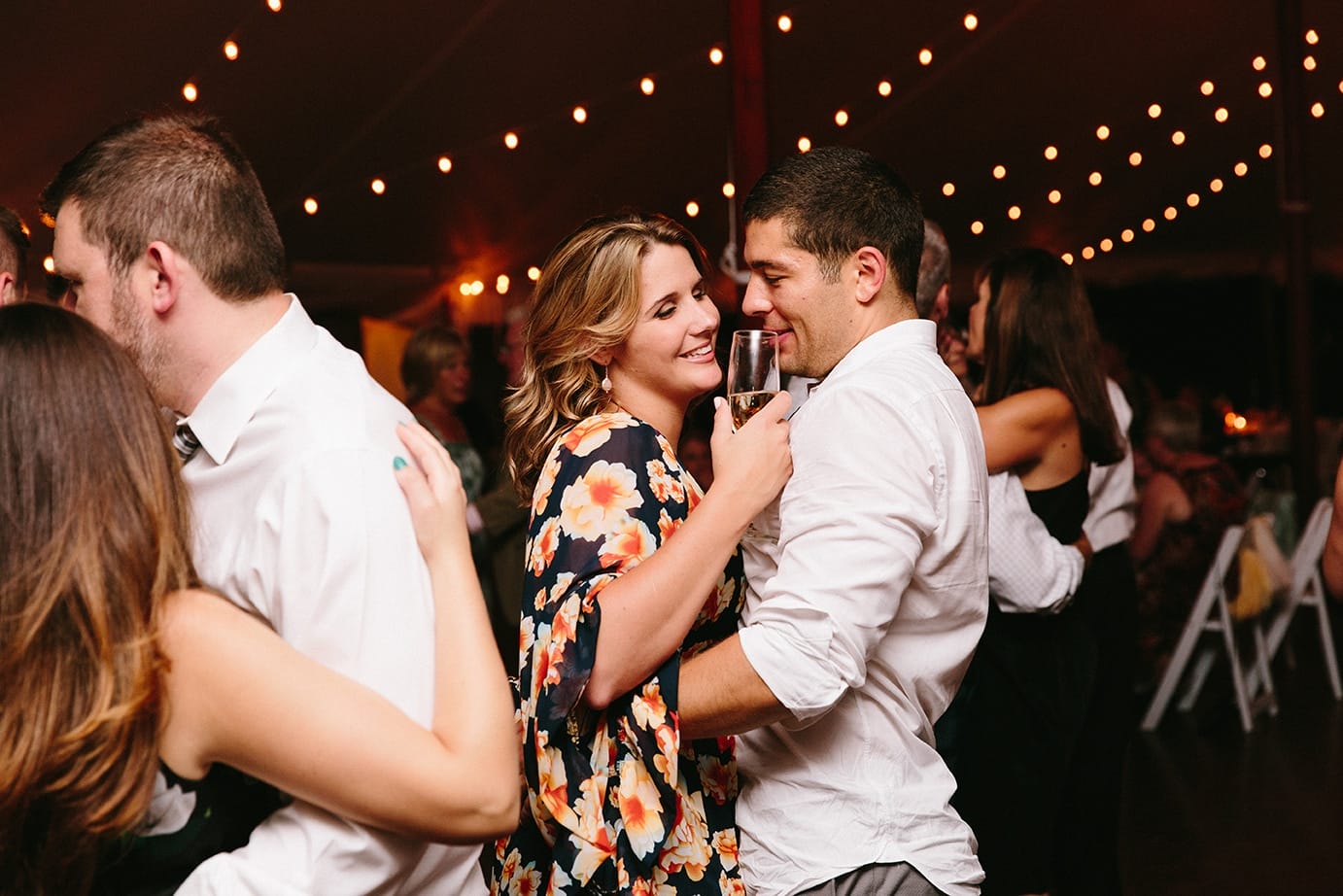 A documentary photograph of guests dancing during a Moraine Farm Wedding in Beverly, Massachusetts
