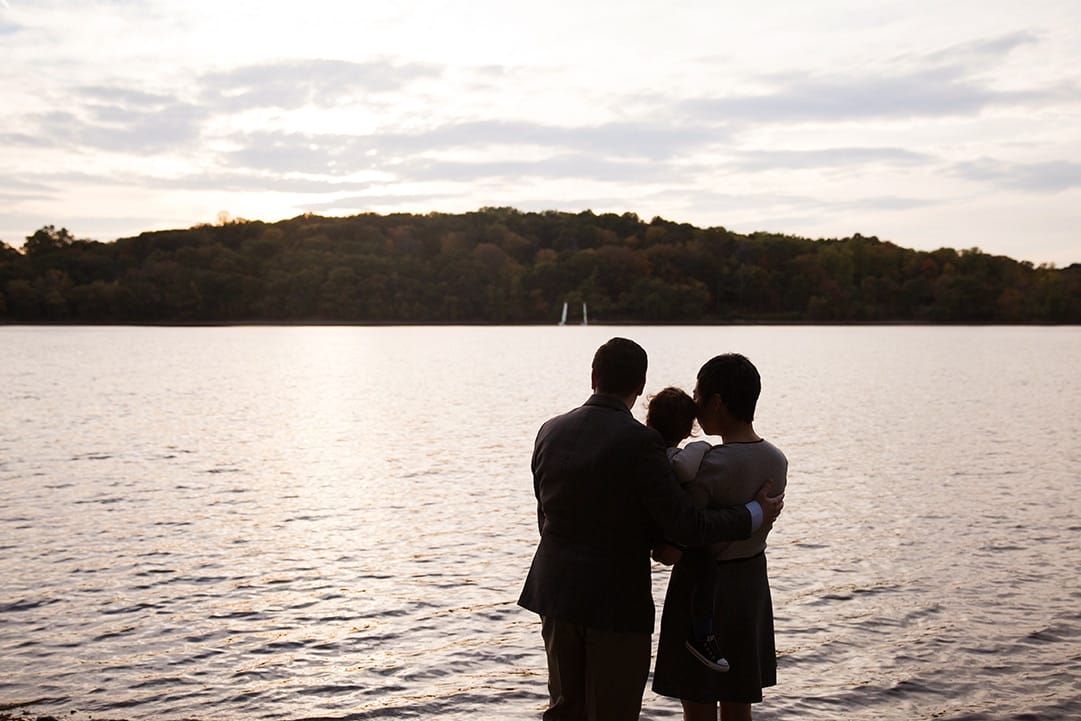 A documentary photograph of a family looking out at the view during their Jamaica Pond family photo session