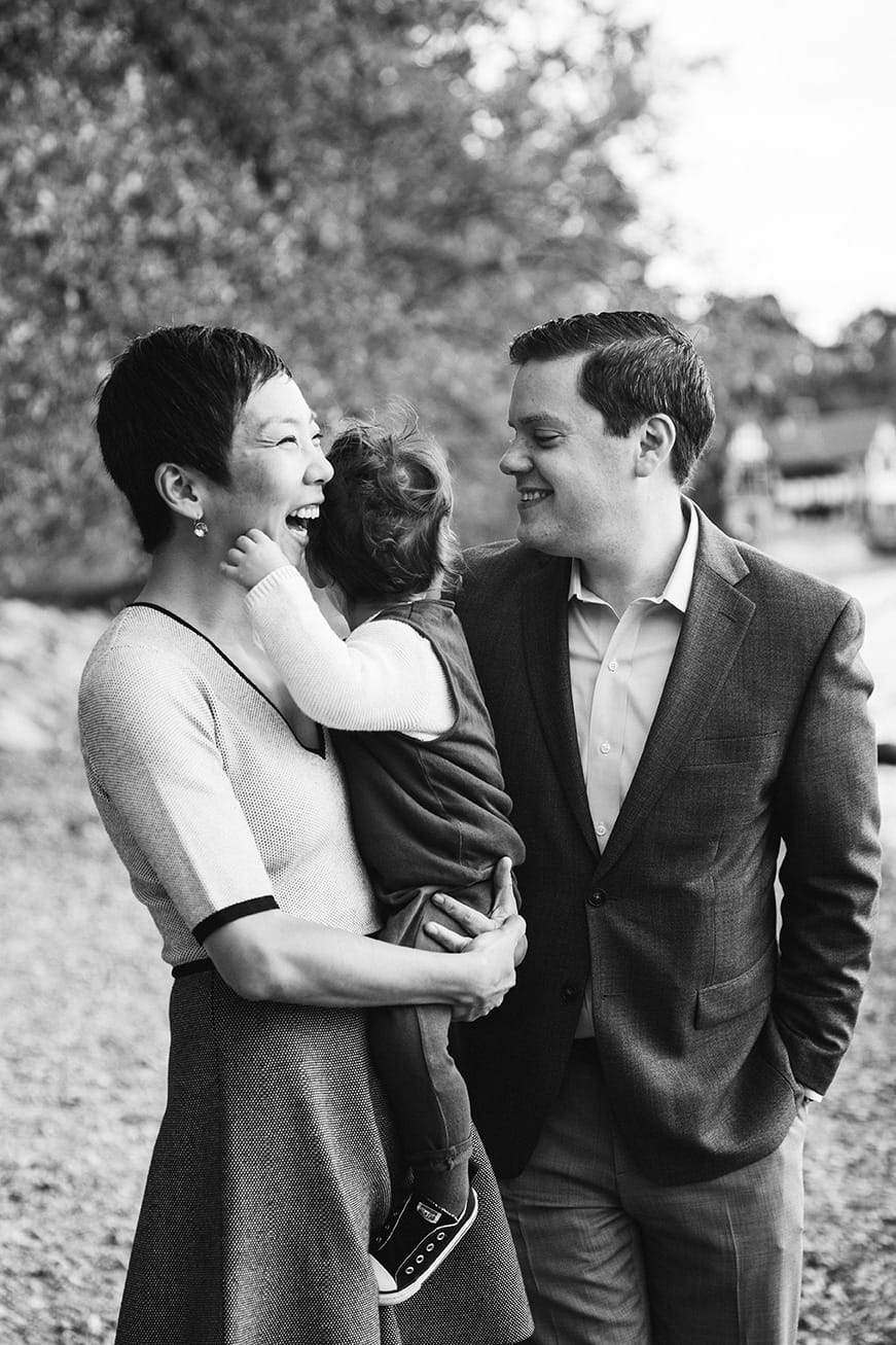A documentary photograph of a toddler hugging his mom during a Jamaica Pond family photo session