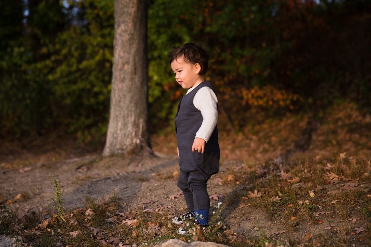 A documentary photograph of a toddler during a jamaica pond family photo session