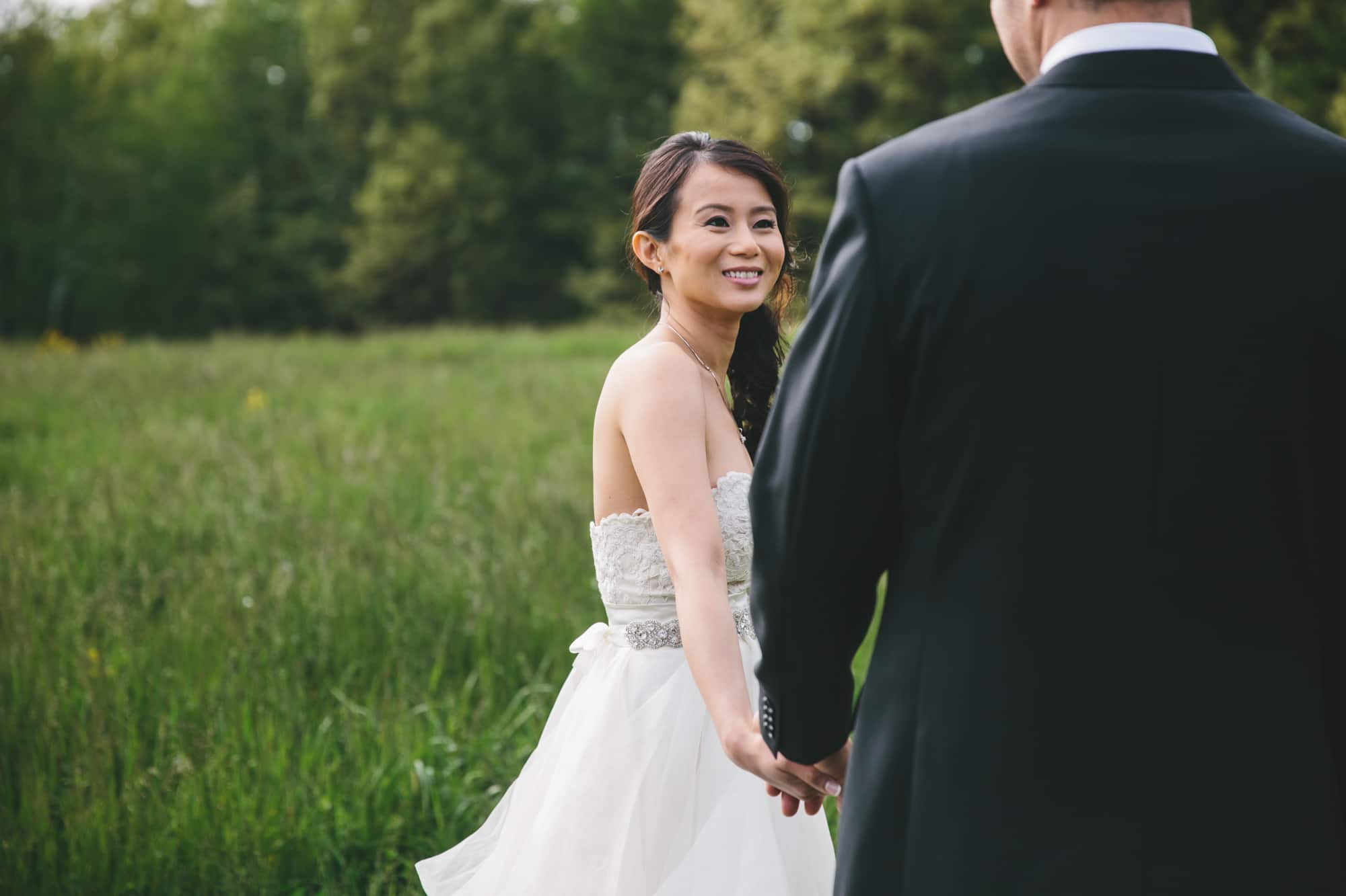 A documentary photograph of a bride smiling with at her groom before their Tower Hill Wedding in Boylston, Massachusetts