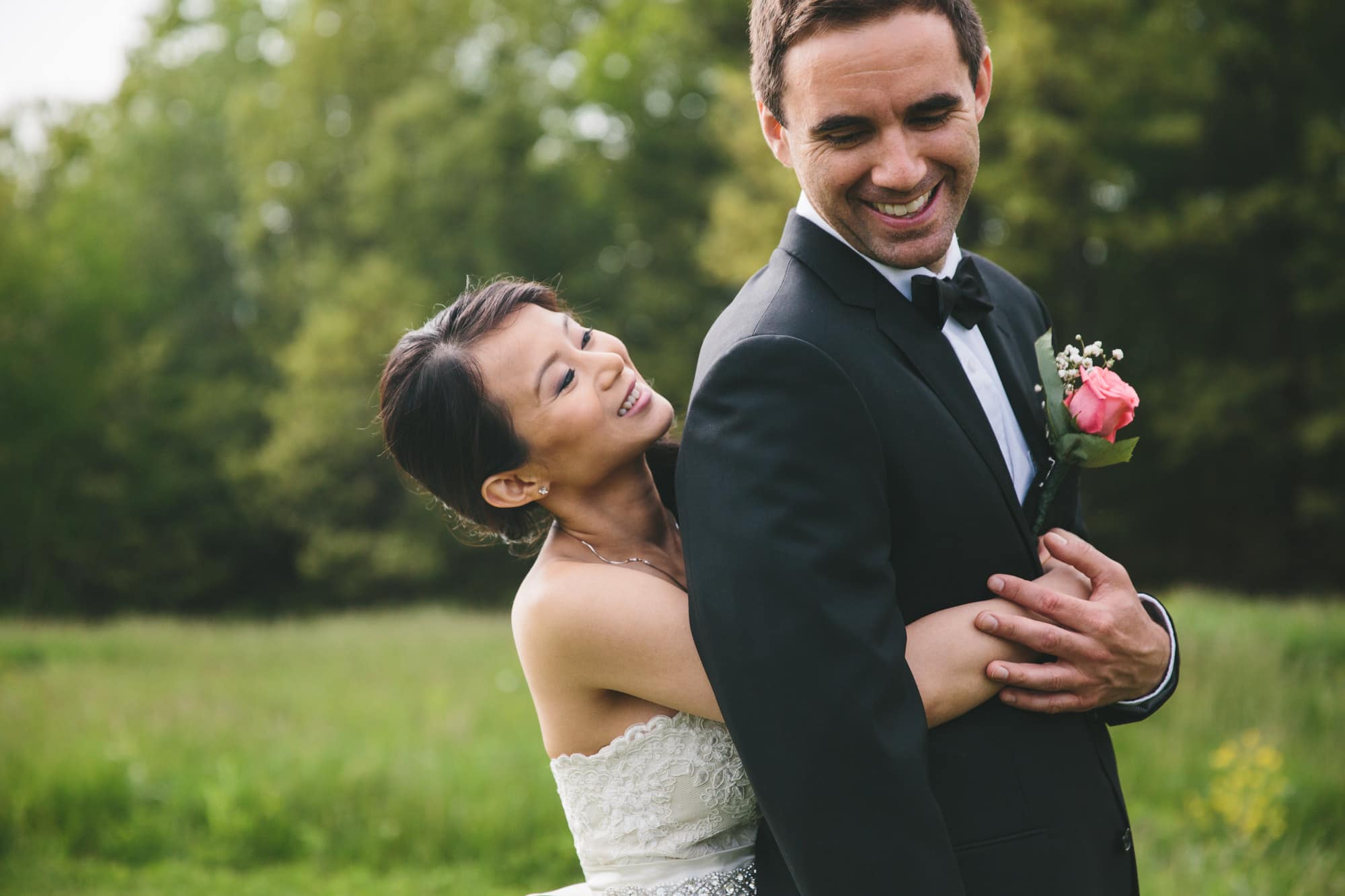 A documentary photograph of a bride hugging her groom before their Tower Hill Wedding in Boylston, Massachusetts