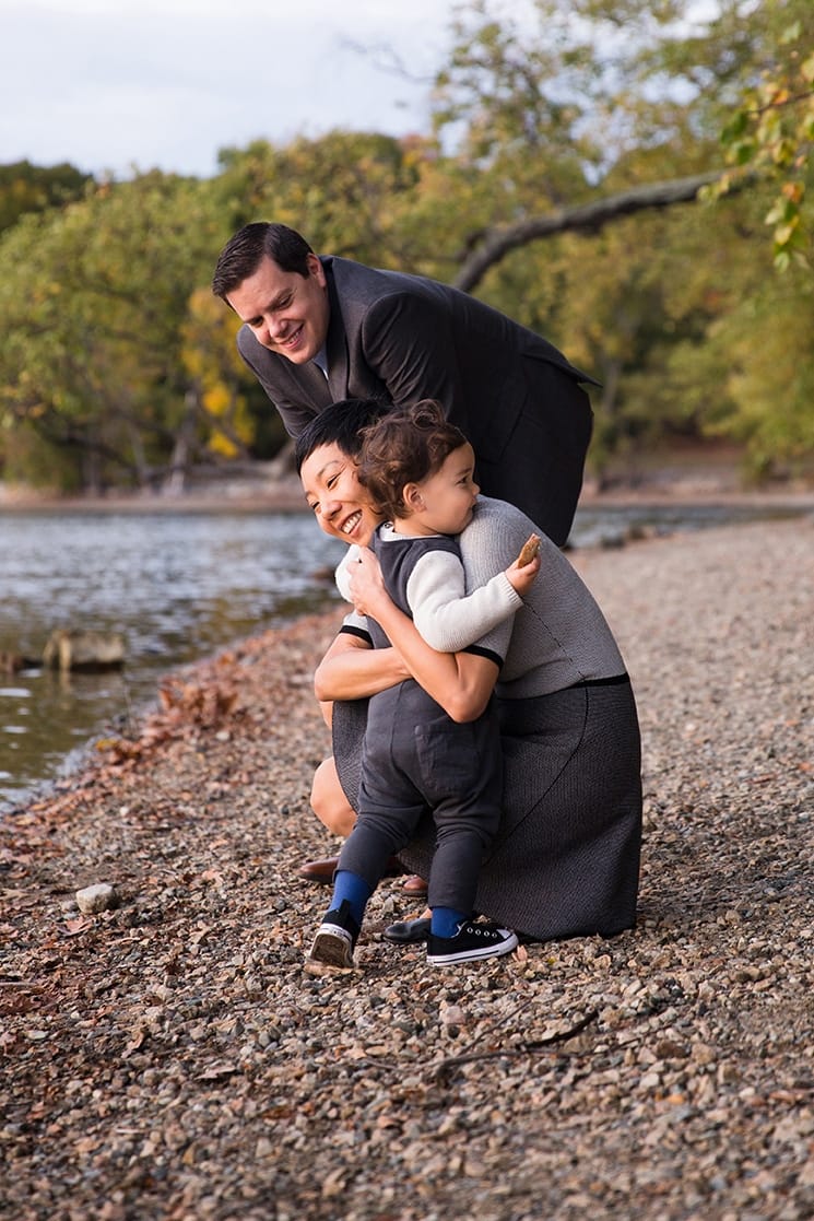 A documentary photograph of a toddler hugging his mom during their Jamaica Pond Family Photo Session in Boston