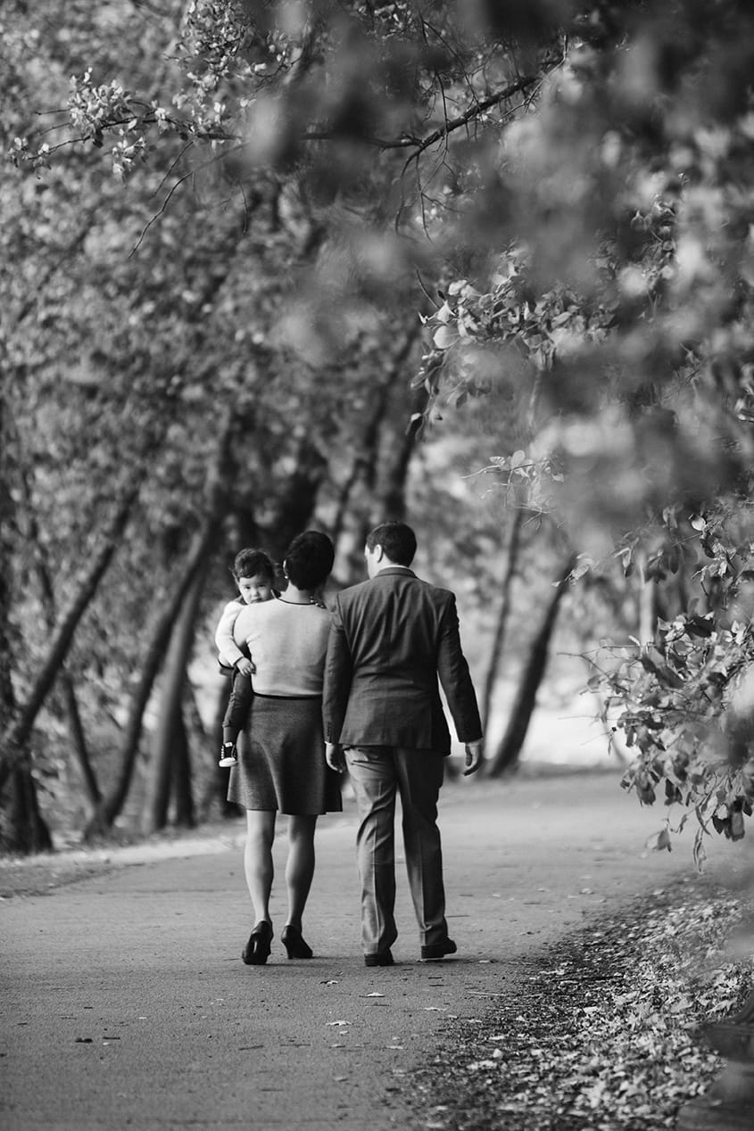 A documentary photograph of a family walking together during their Jamaica Pond Family Photo Session in Boston