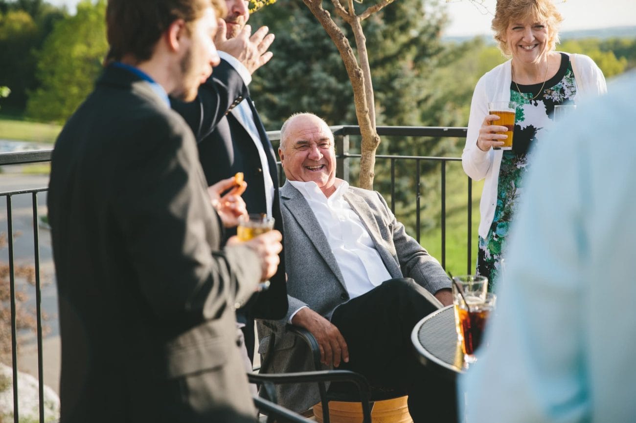 A documentary photograph of guests laughing during a Tower Hill Wedding in Boylston, Massachusetts