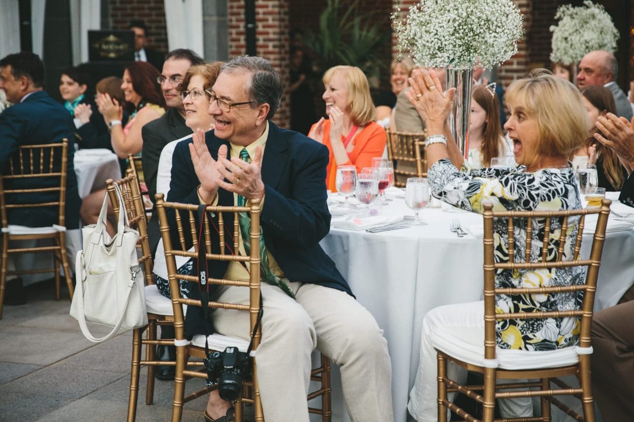 A documentary photograph of guest cheering as the bride and groom enter their Tower Hill Wedding Reception in Boylston, Massachusetts