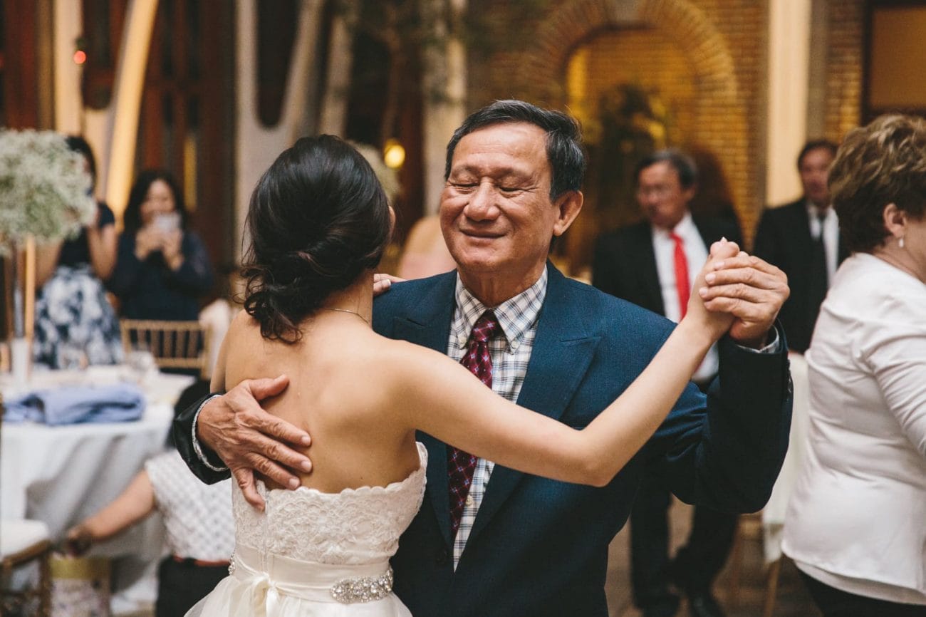 A documentary photograph of a bride dancing with her father during her Tower Hill Wedding reception in Boylston, Massachusetts