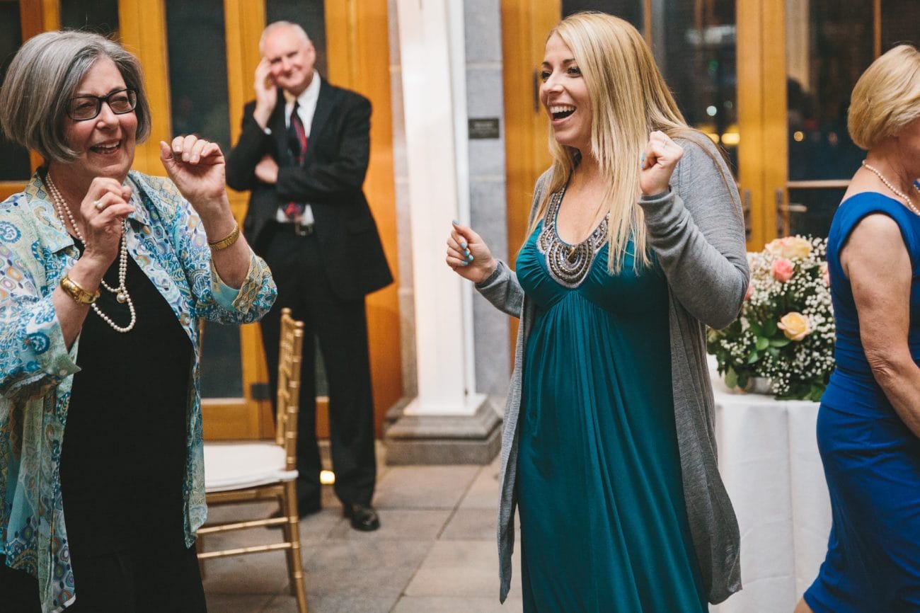 A documentary photograph of guests dancing during a tower hill wedding reception in Boylston, Massachusetts