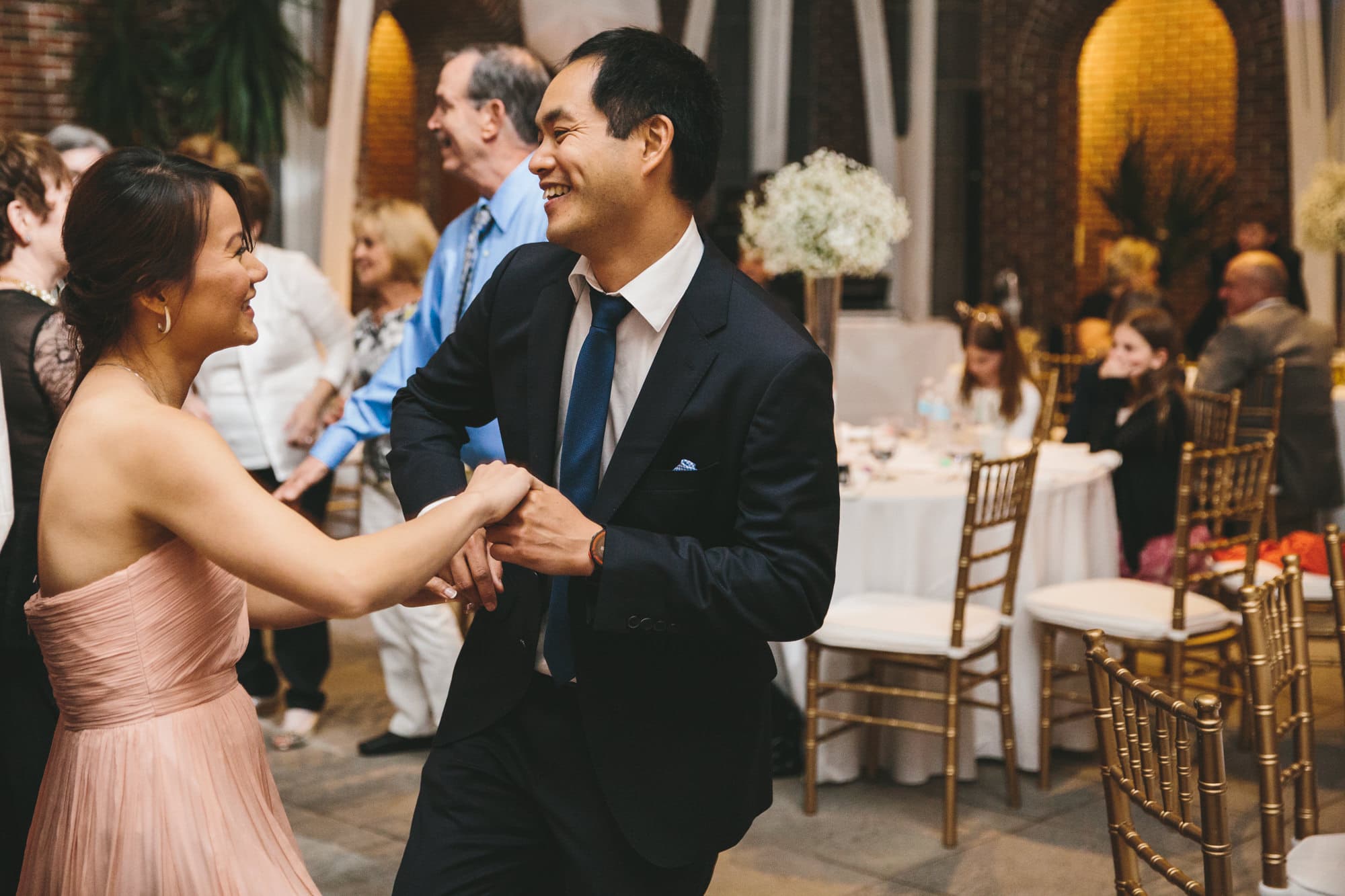 A documentary photograph of guests dancing during a tower hill wedding reception in Boylston, Massachusetts