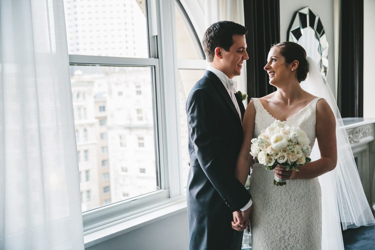 A documentary portrait of a bride and groom seeing each other at the Ames Hotel before their State Room Wedding
