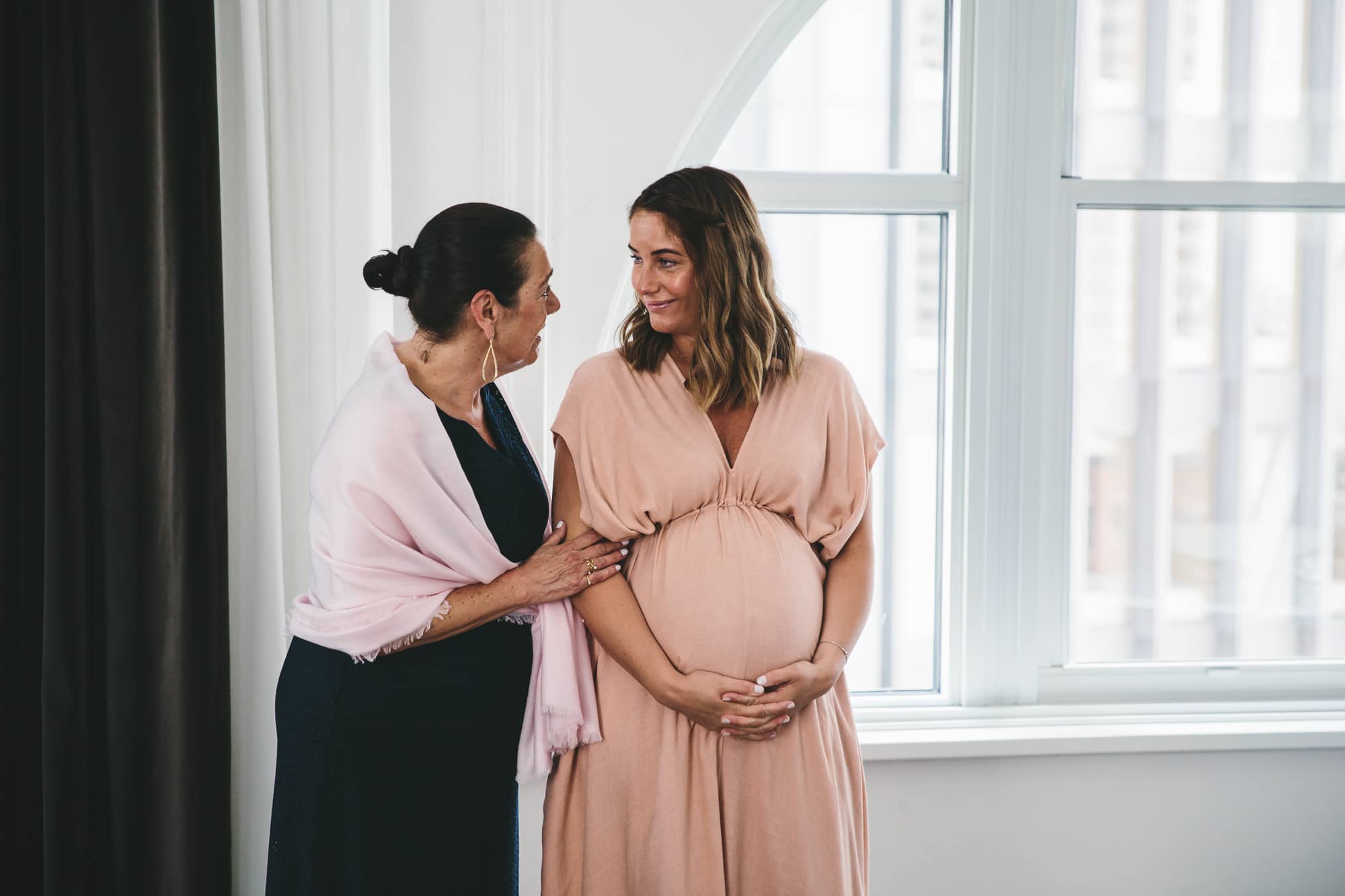 A documentary photograph of family talking before a State Room Wedding in Boston, Massachusetts