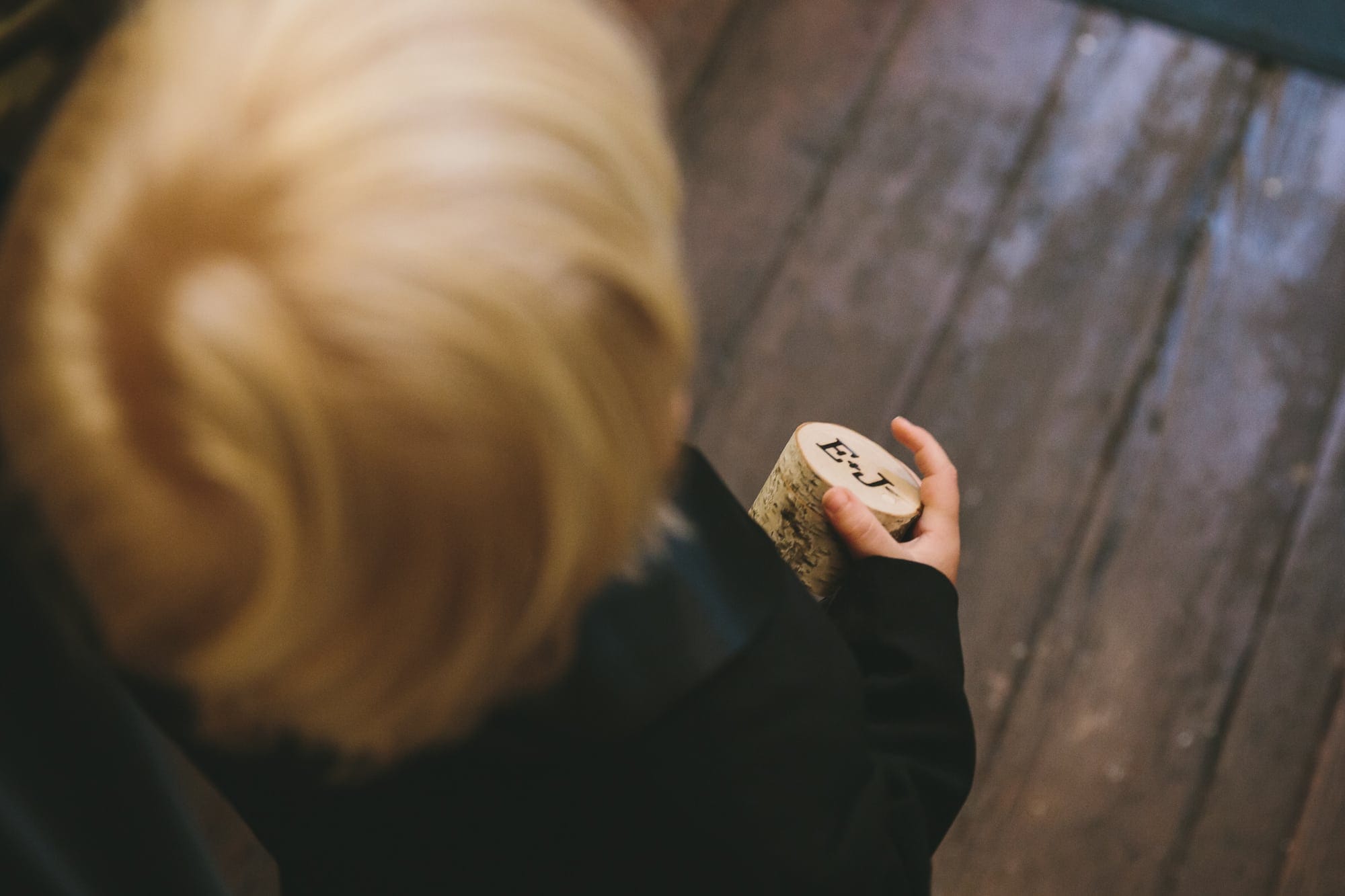 A documentary photograph of the ring bearer holding the wedding rings before a old south meeting house wedding ceremony and State Room Wedding reception