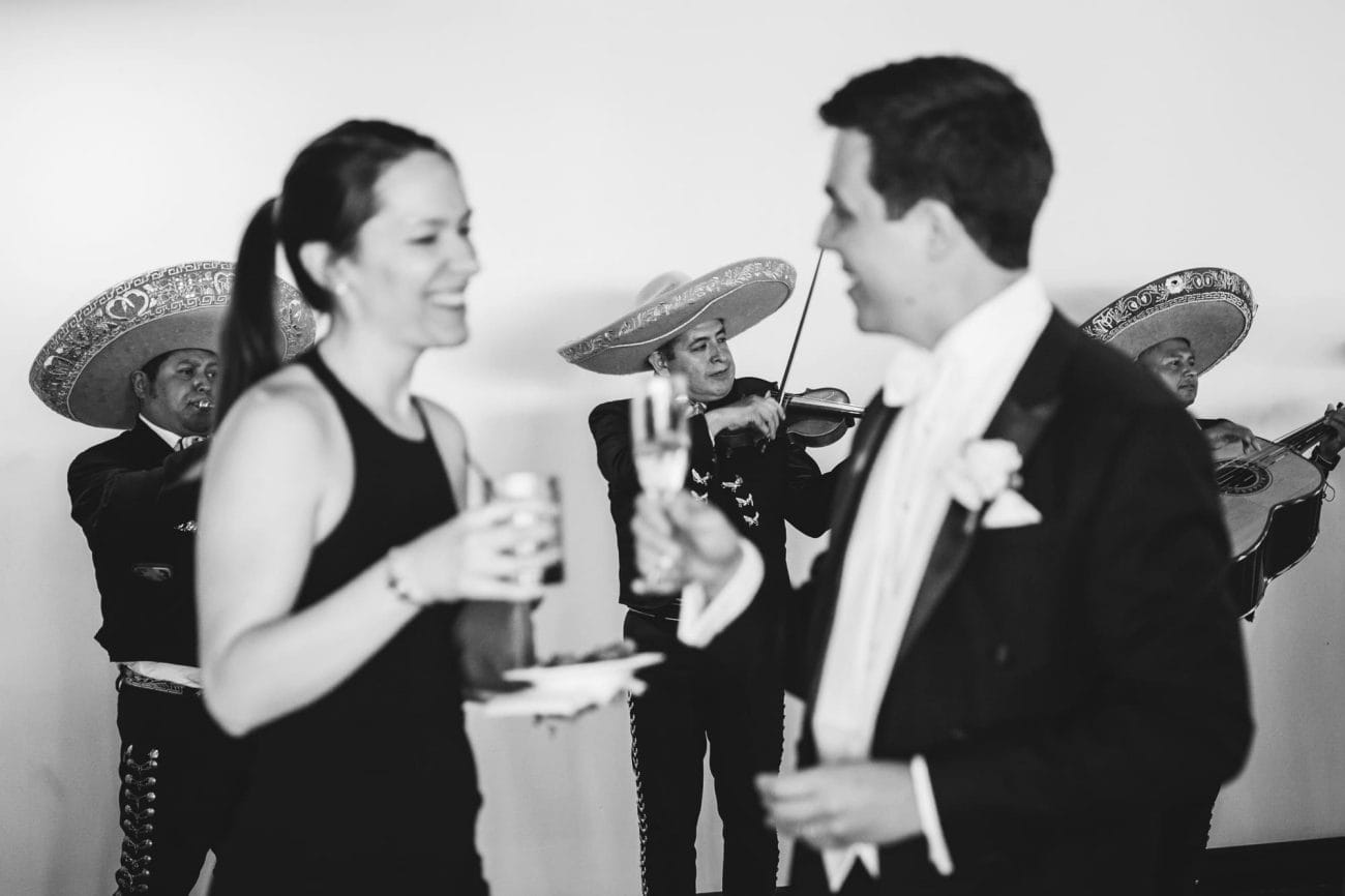 A documentary photograph of guests talking during a state room wedding reception