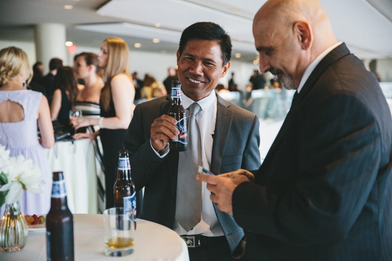 A documentary photograph of guests talking during a state room wedding reception