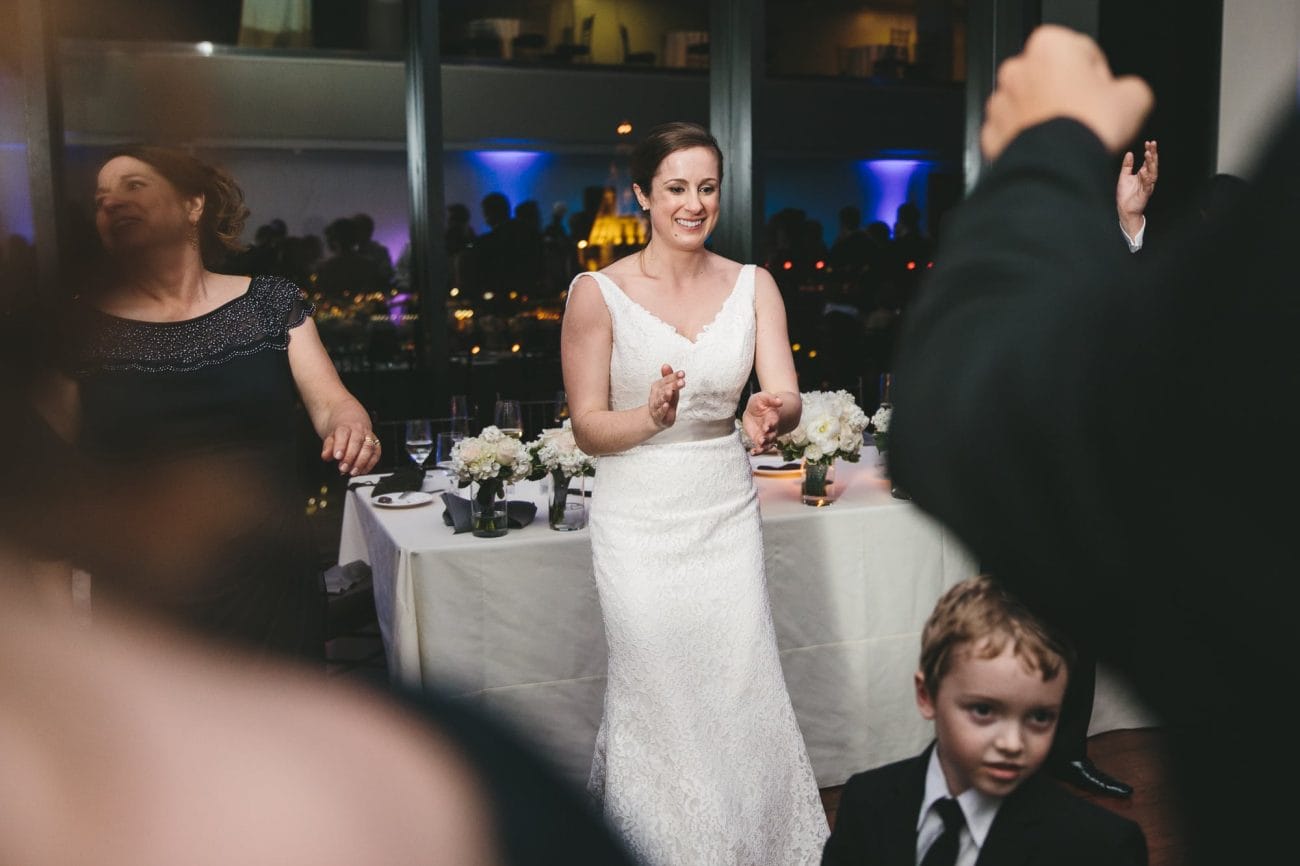 A documentary photograph of a bride dancing at her State Room Wedding