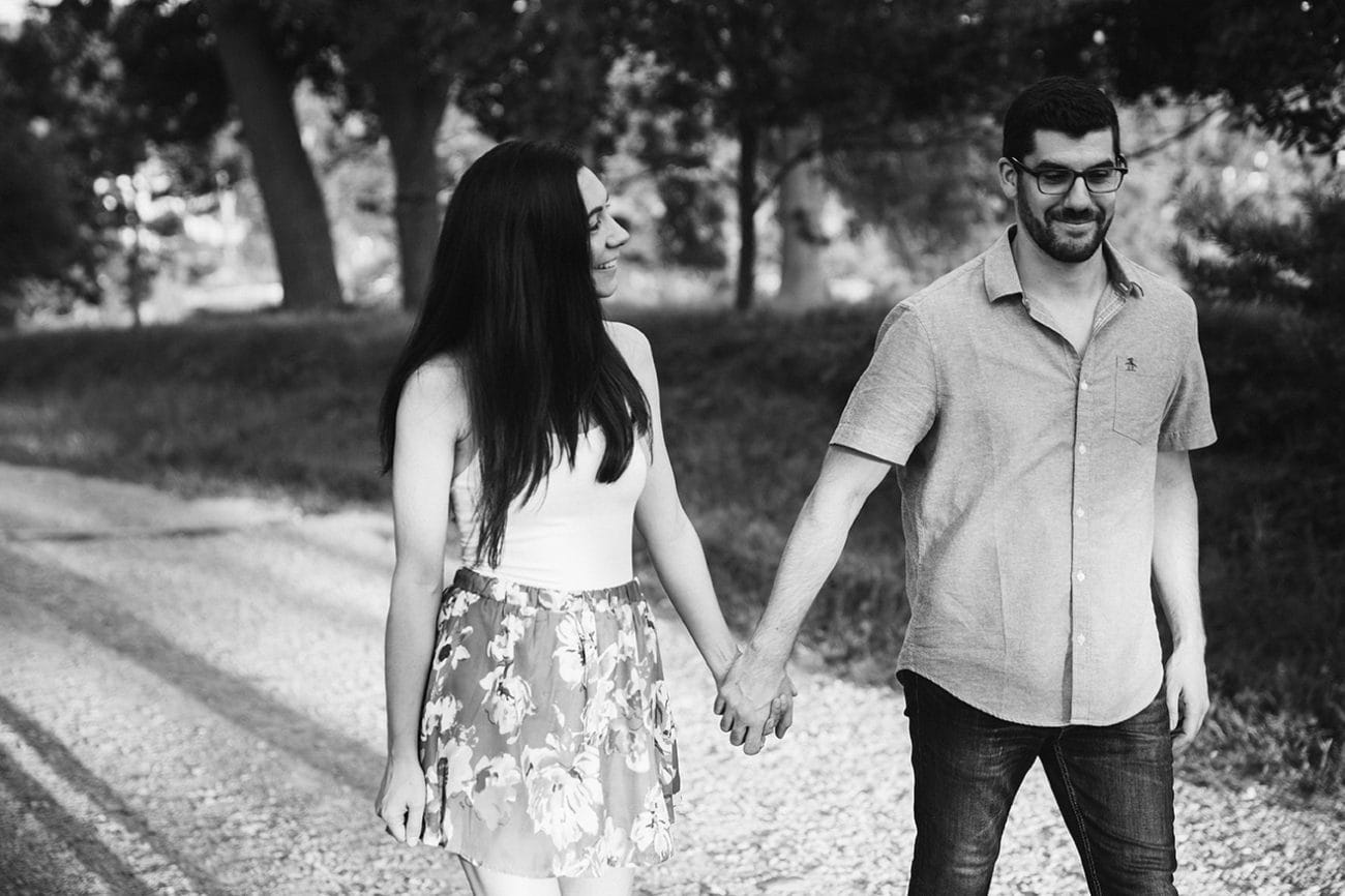 A documentary photograph of a couple walking together during their engagement session at the World's End in Hingham, Massachusetts