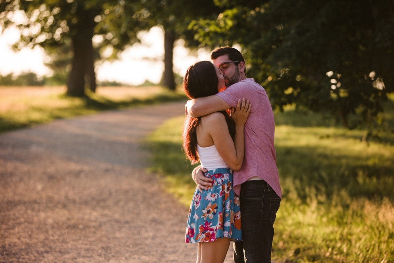 A documentary photograph of a couple kissing during their World's End Engagement Session in Hingham, Massachusetts