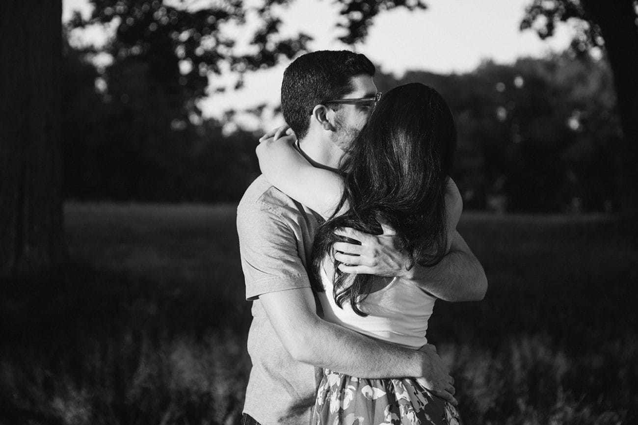 A documentary photograph of a couple hugging during their World's End Engagement Session in Hingham, Massachusetts