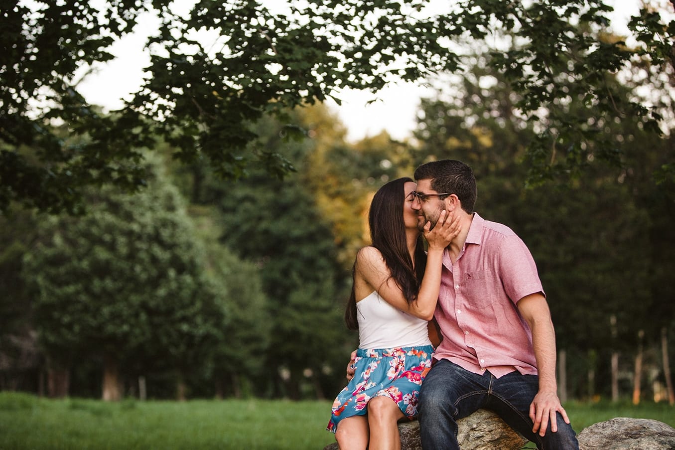 A documentary photograph of a couple kissing during their World's End Engagement Session in Hingham, Massachusetts