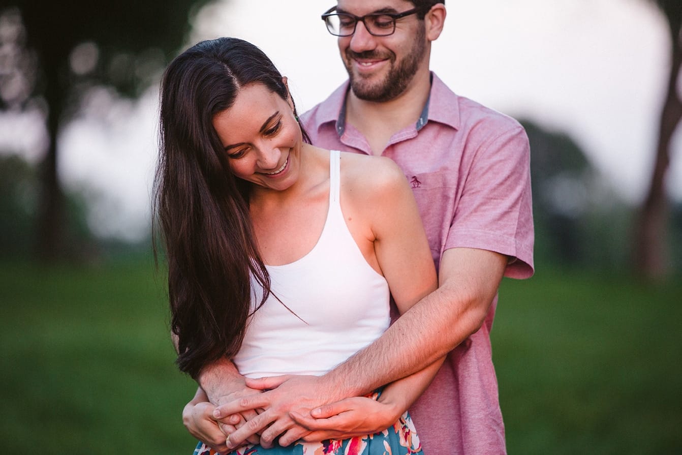 A couple laugh together during their documentary engagement session at the World's End in Hingham, Massachusetts