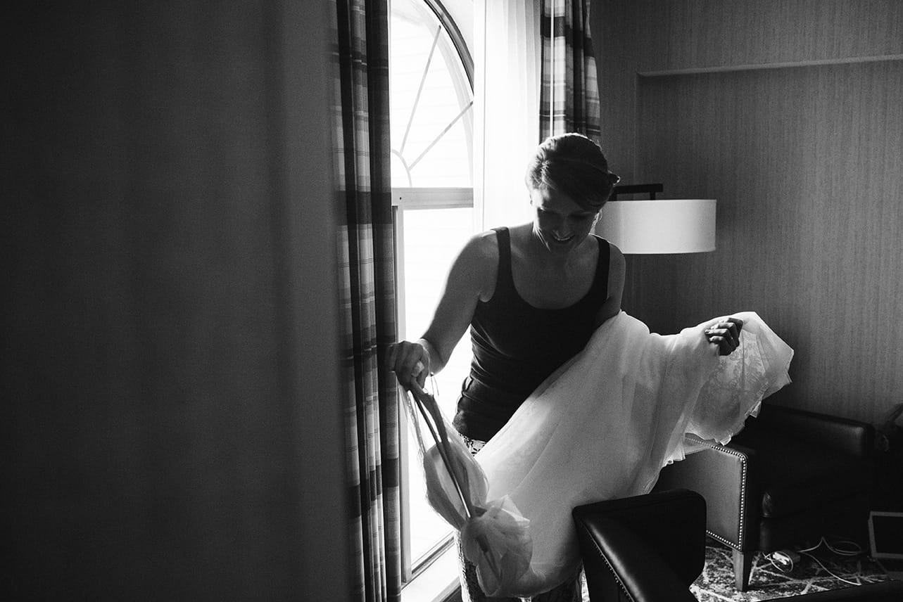 A documentary photograph of a bride walking with her wedding dress before her plimoth plantation wedding in plymouth, massachusetts