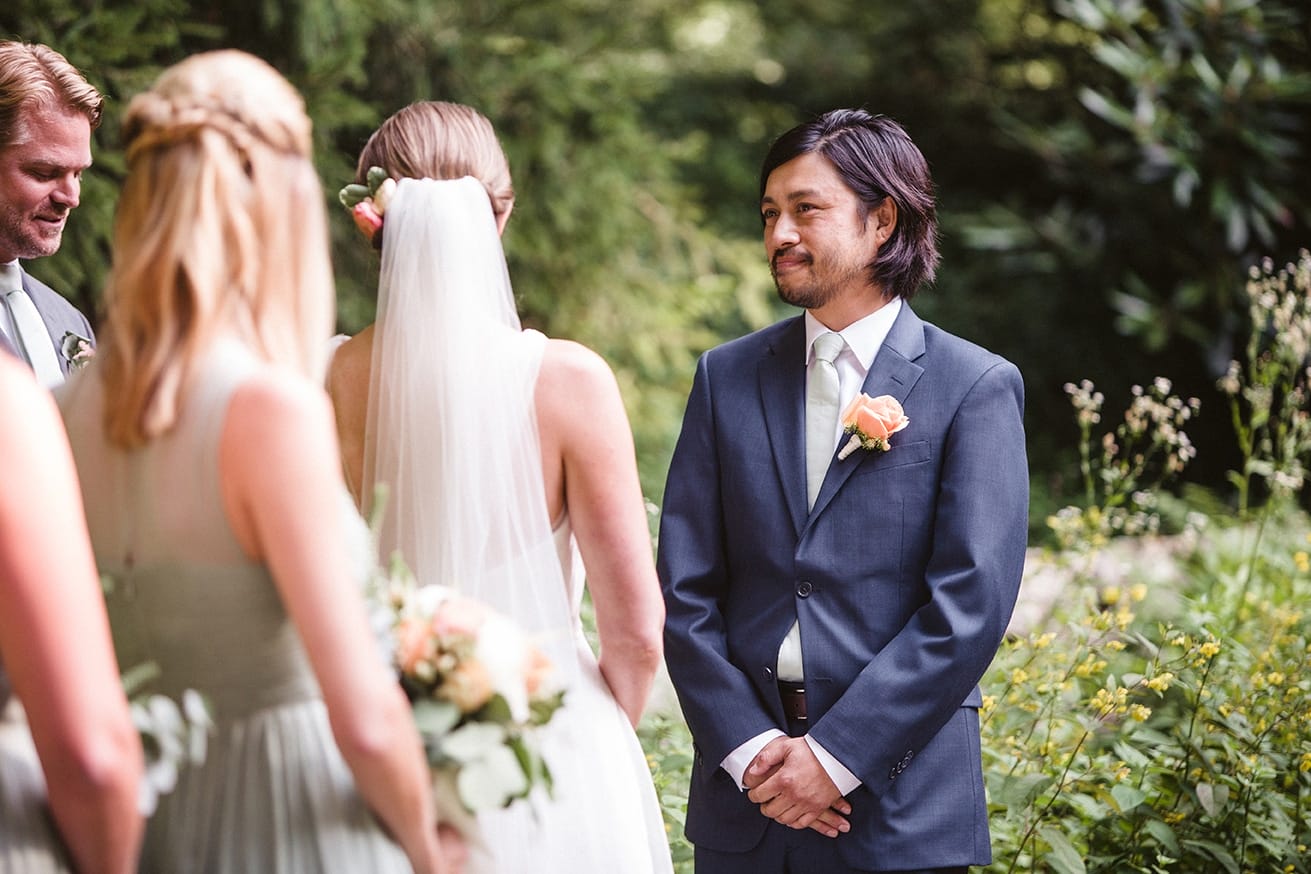 A documentary photograph of a groom watching his bride during a plimoth plantation wedding in plymouth, massachusetts