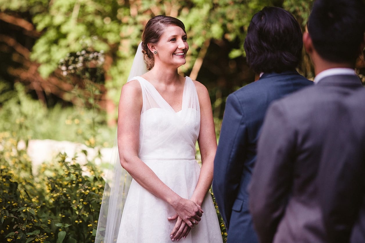 A documentary photograph of a bride smiling during her plimoth plantation wedding ceremony in plymouth, massachusetts