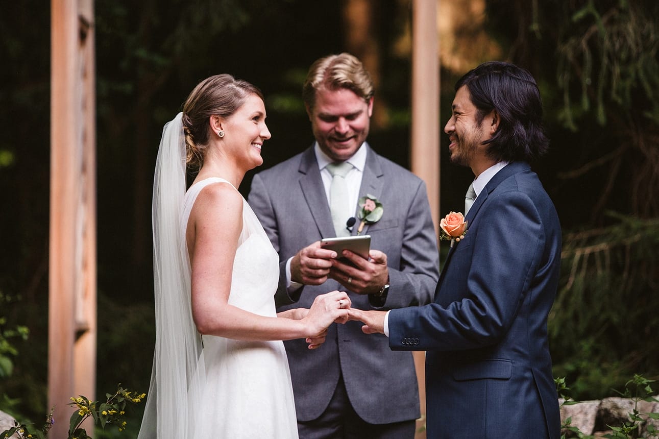 A documentary photograph of a bride and groom exchanging rings during their plimoth plantation wedding ceremony in plymouth, massachusetts