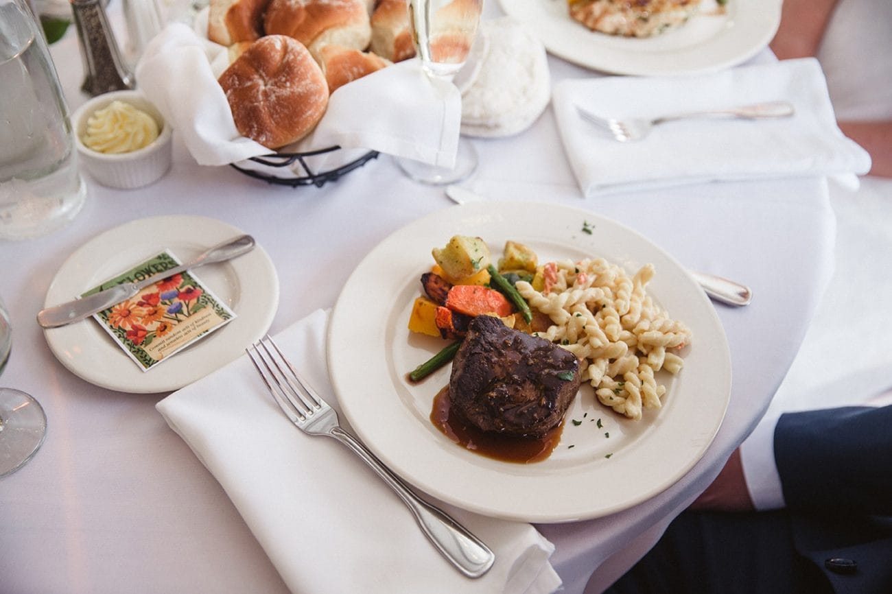 A documentary photograph of the groom's dinner during his plimoth plantation wedding in plymouth, massachusetts