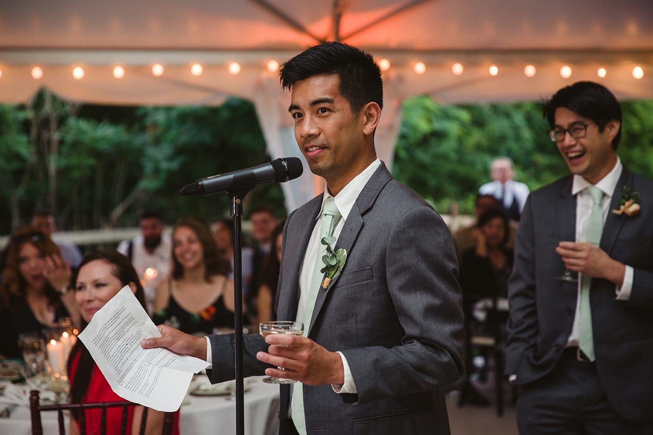 A documentary photograph of the best man giving a toast during a plimoth plantation wedding in plymouth, massachusetts